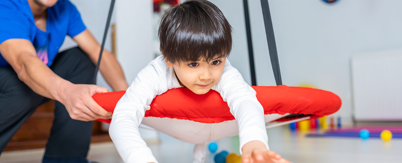 A child is looking ahead at a toy. 