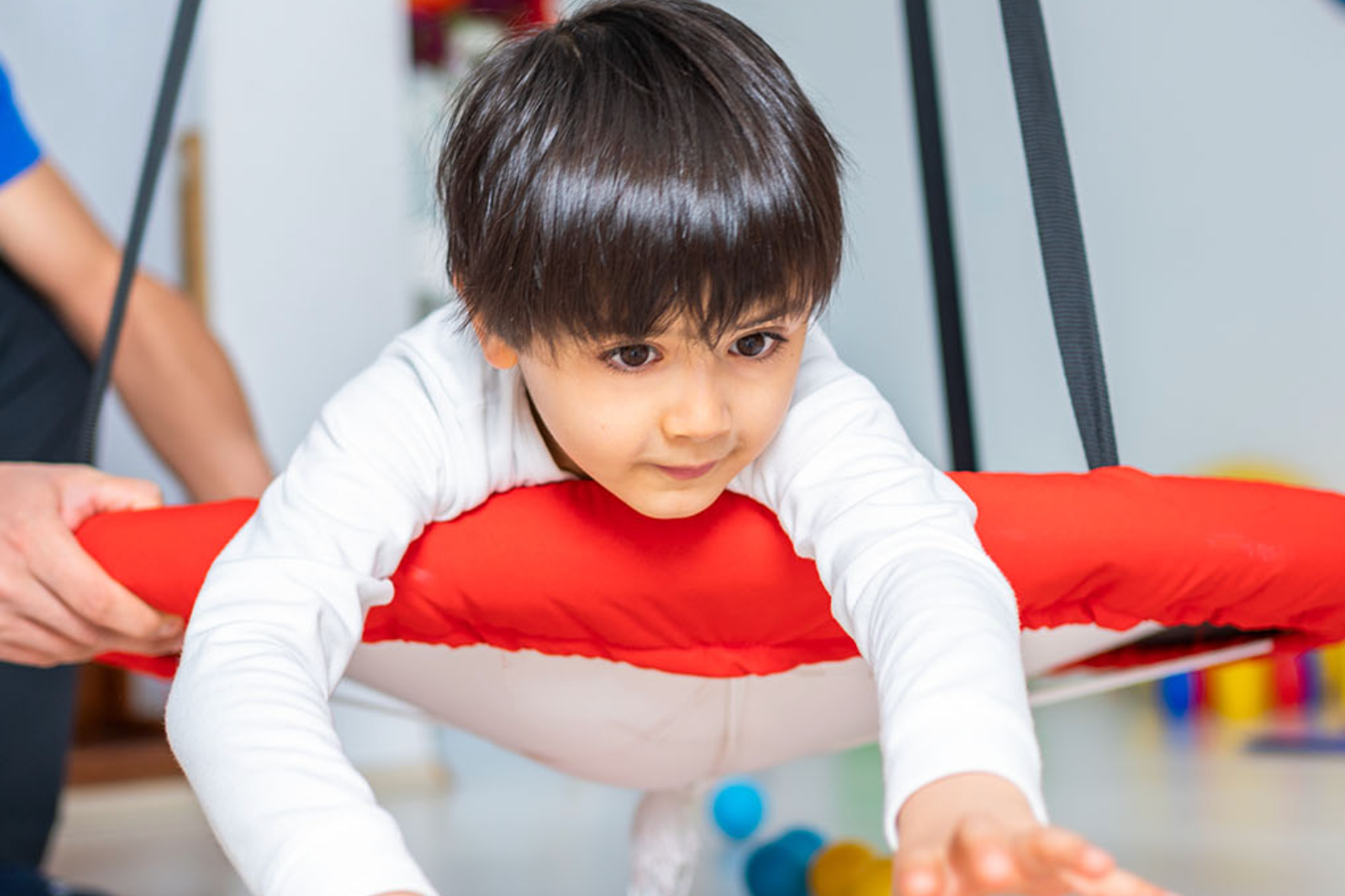 A child is looking ahead at a toy. 